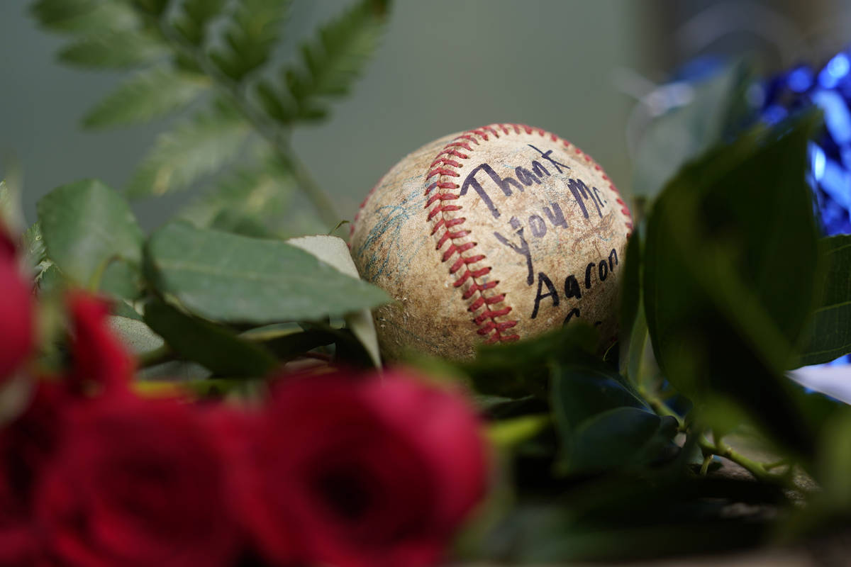A baseball left by a fan rests in a growing memorial Friday, Jan. 22, 2021, in Atlanta, near th ...