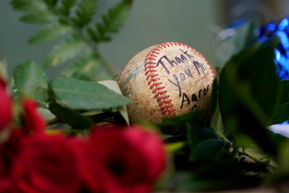 A baseball left by a fan rests in a growing memorial Friday, Jan. 22, 2021, in Atlanta, near th ...
