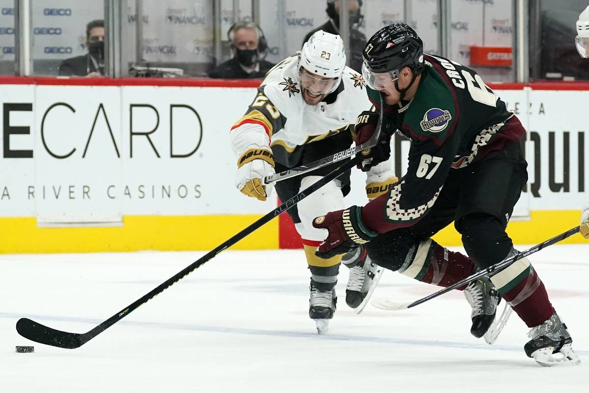Arizona Coyotes left wing Lawson Crouse (67) gets a high stick to the face from Vegas Golden Kn ...