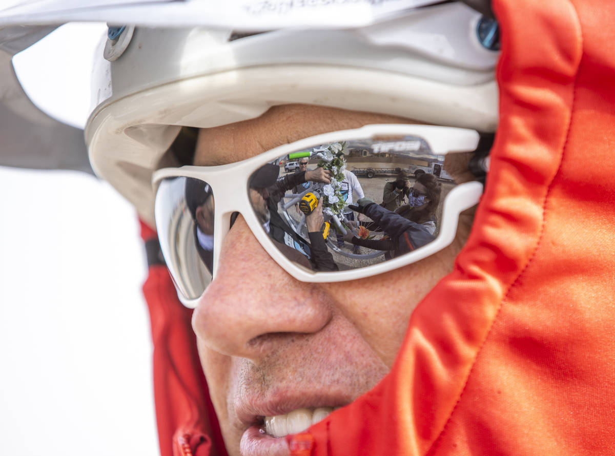 The crew are reflected in Jared Fischer's sunglasses as they mount the newest bike near the int ...