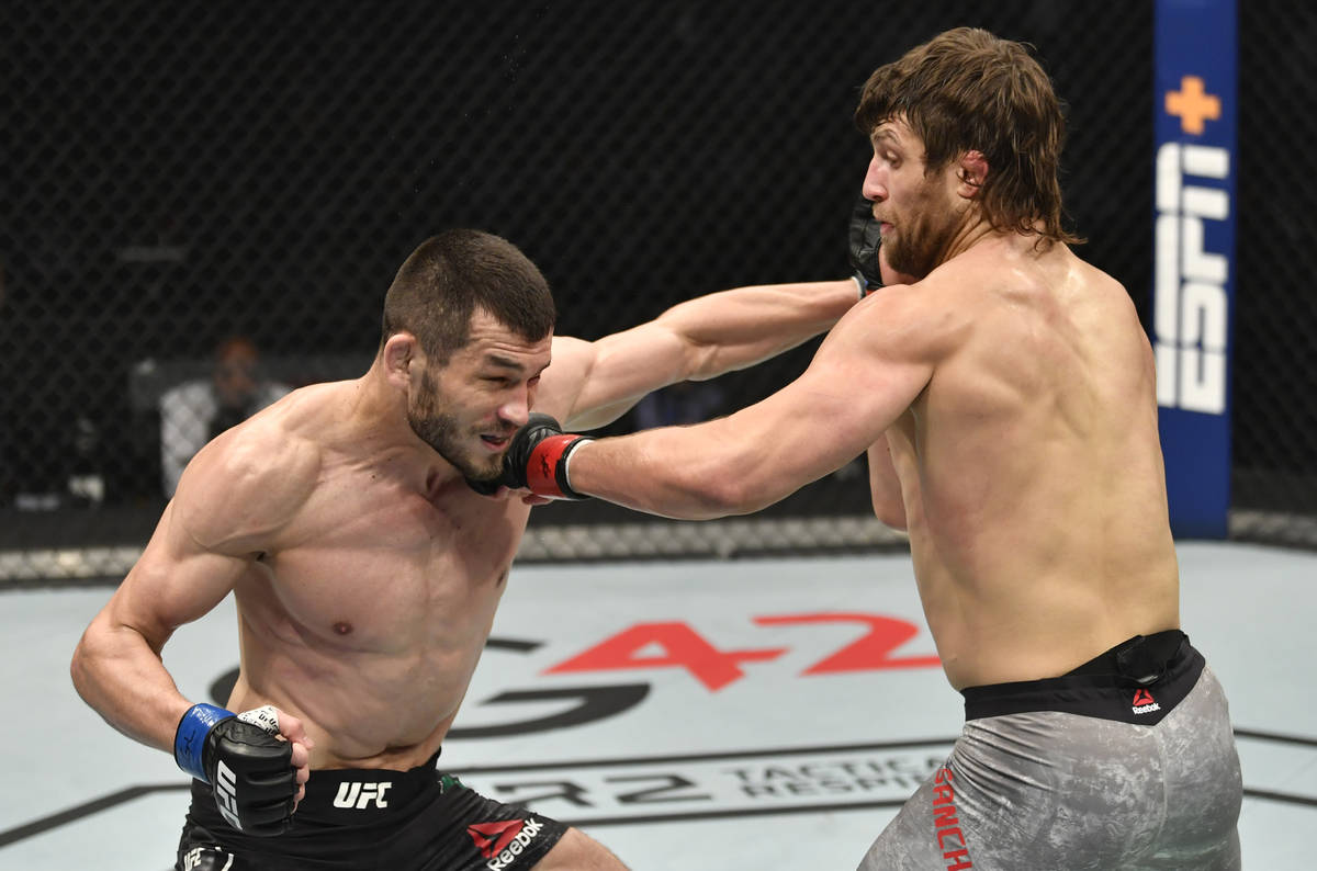 ABU DHABI, UNITED ARAB EMIRATES - JANUARY 23: (R-L) Andrew Sanchez punches Makhmud Muradov of U ...