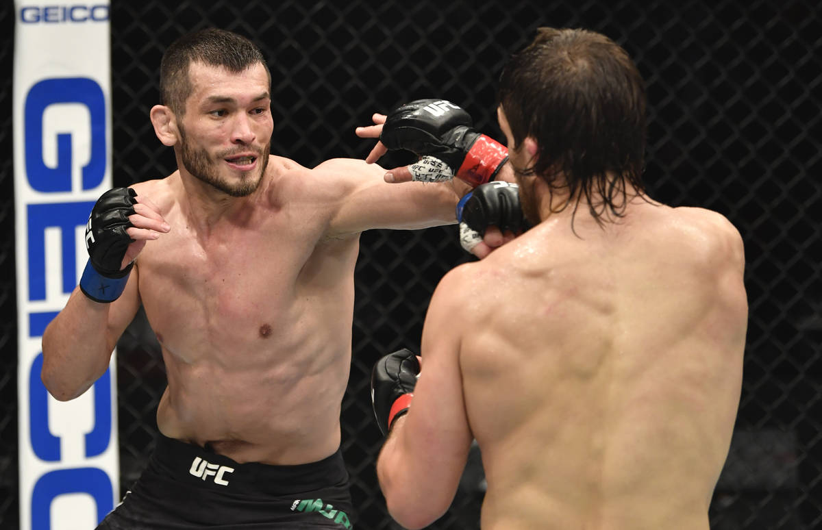 ABU DHABI, UNITED ARAB EMIRATES - JANUARY 23: (L-R) Makhmud Muradov of Uzbekistan punches Andre ...