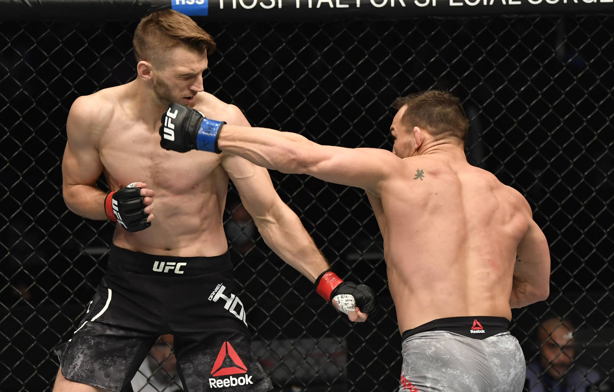 ABU DHABI, UNITED ARAB EMIRATES - JANUARY 23: (R-L) Michael Chandler punches Dan Hooker of New ...