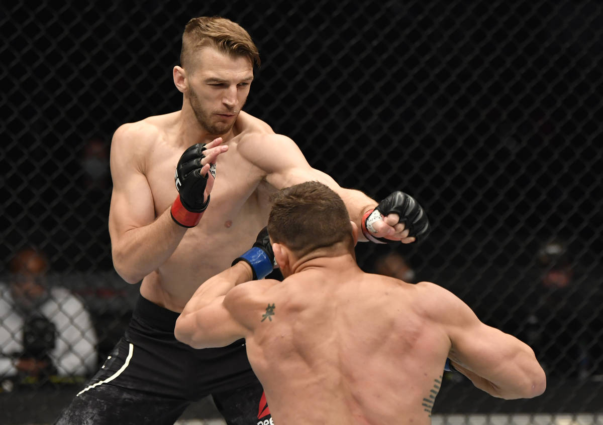 ABU DHABI, UNITED ARAB EMIRATES - JANUARY 23: (L-R) Dan Hooker of New Zealand punches Michael C ...