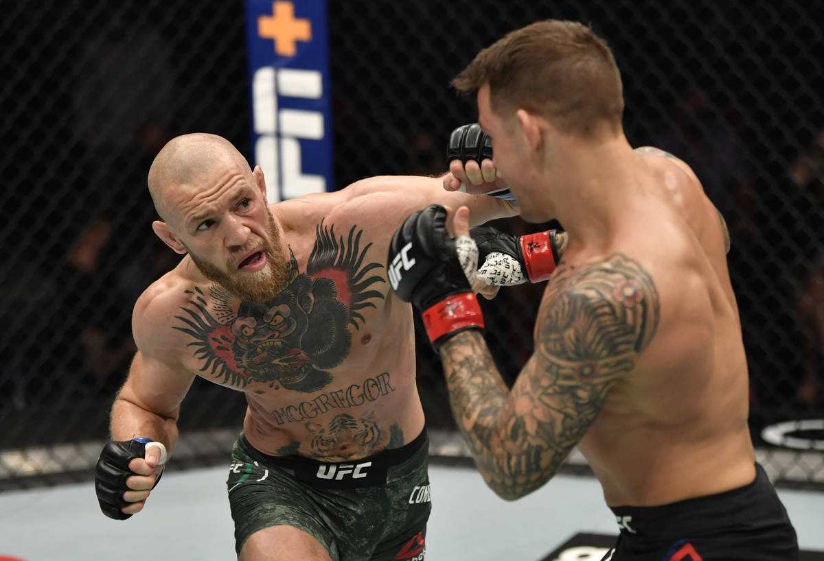 ABU DHABI, UNITED ARAB EMIRATES - JANUARY 23: (L-R) Conor McGregor of Ireland punches Dustin Po ...