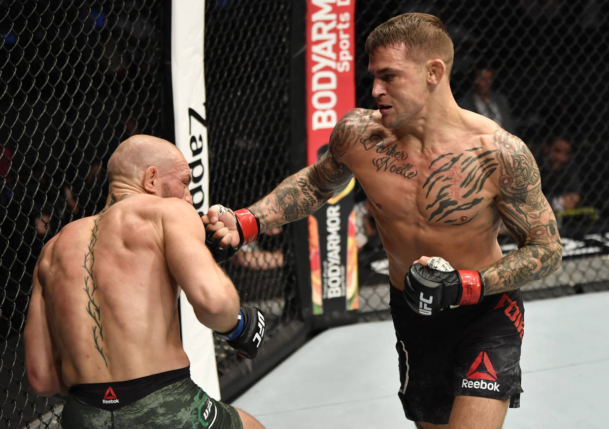 ABU DHABI, UNITED ARAB EMIRATES - JANUARY 23: (R-L) Dustin Poirier punches Conor McGregor of Ir ...