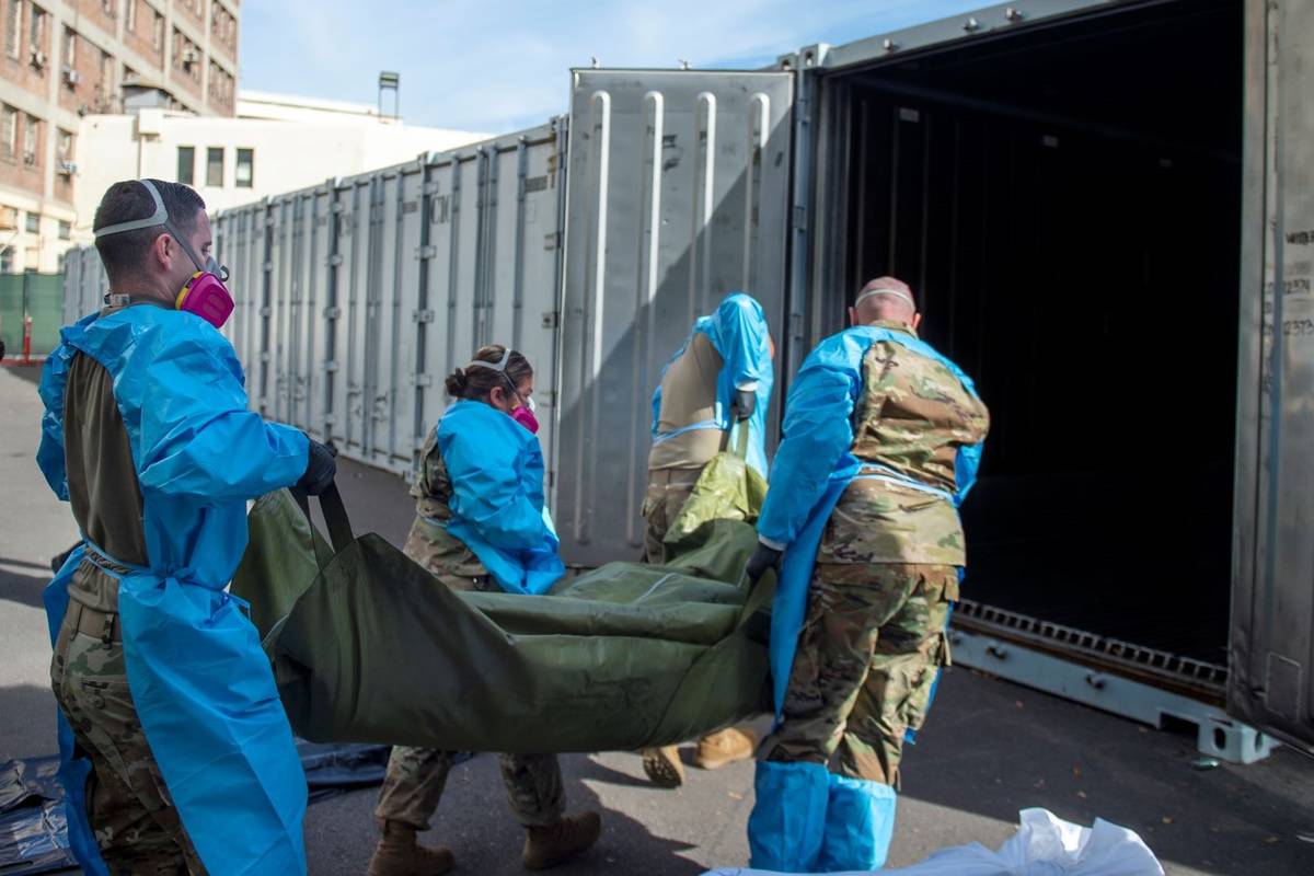 National Guard members assisting with processing COVID-19 deaths and placing them into temporar ...