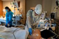 FILE - In this Nov. 19, 2020, file photo, Dr. Rafik Abdou checks on a COVID-19 patient at Provi ...