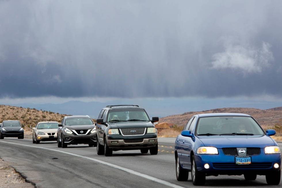 Dark clouds hover over the Las Vegas Valley as visitors drive into Red Rock National Conservati ...