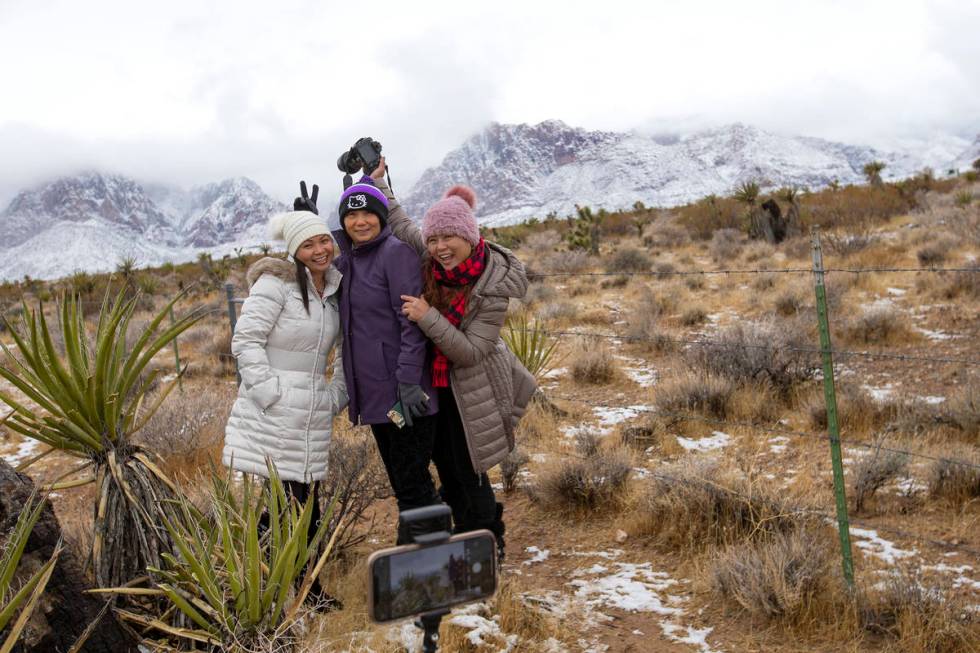 Tina Fang, left, Jenet Lu and Angel Fang pose for a photo while enjoying the snow at Red Rock N ...