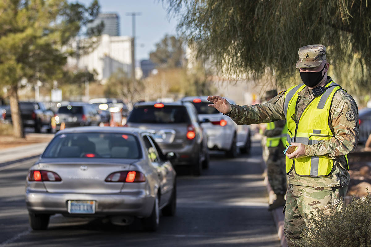 Army National Guard members direct traffic at the COVID-19 testing center at the UNLV Stan Fult ...