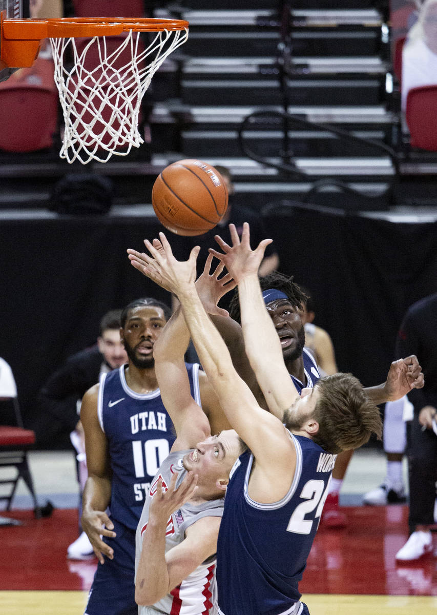 Utah State's center Neemias Queta (23) blocks a attempted point by UNLV's Moses Wood (1) during ...