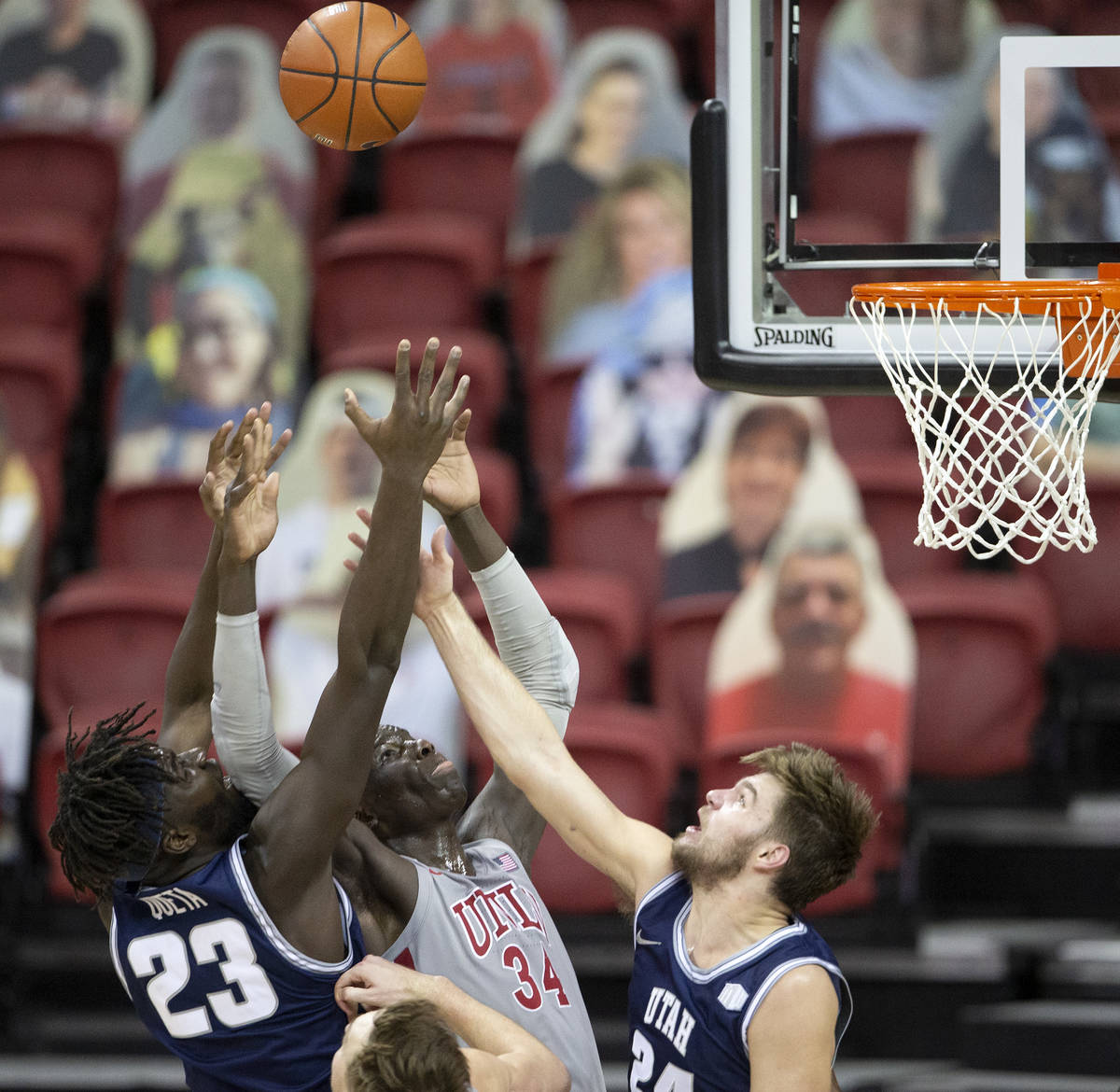 UNLV's forward Cheikh Mbacke Diong (34) attempts to block a point by Utah State's center Neemia ...
