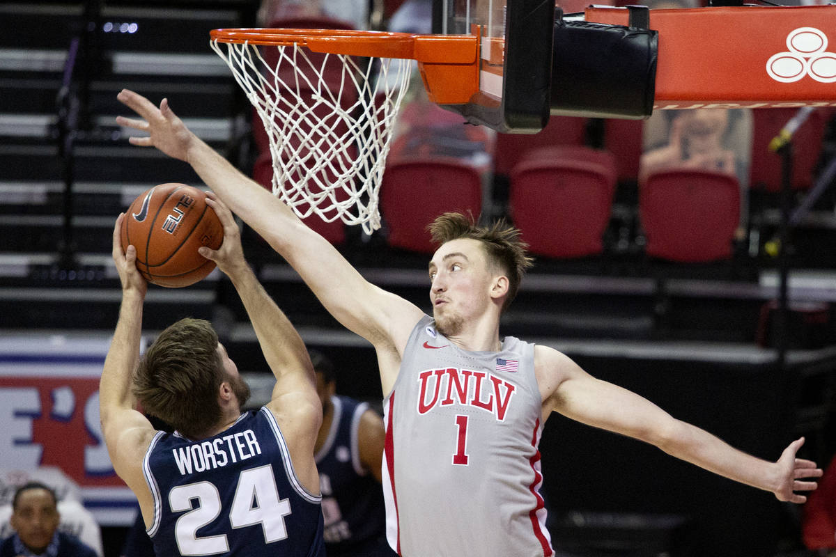 UNLV's forward Moses Wood (1) blocks a point by Utah State's guard Rollie Worster (24) during t ...