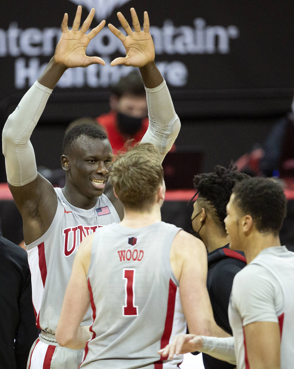 UNLV's forward Cheikh Mbacke Diong (34) reaches to high five his teammates after winning a bask ...