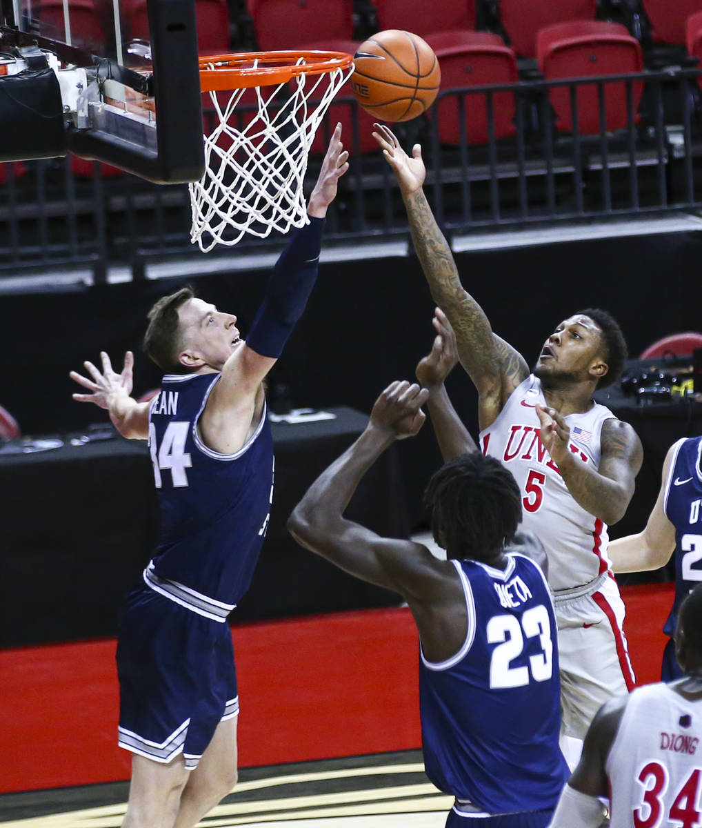 UNLV Rebels guard David Jenkins Jr. (5) attempts a shot under pressure from Utah State Aggies f ...