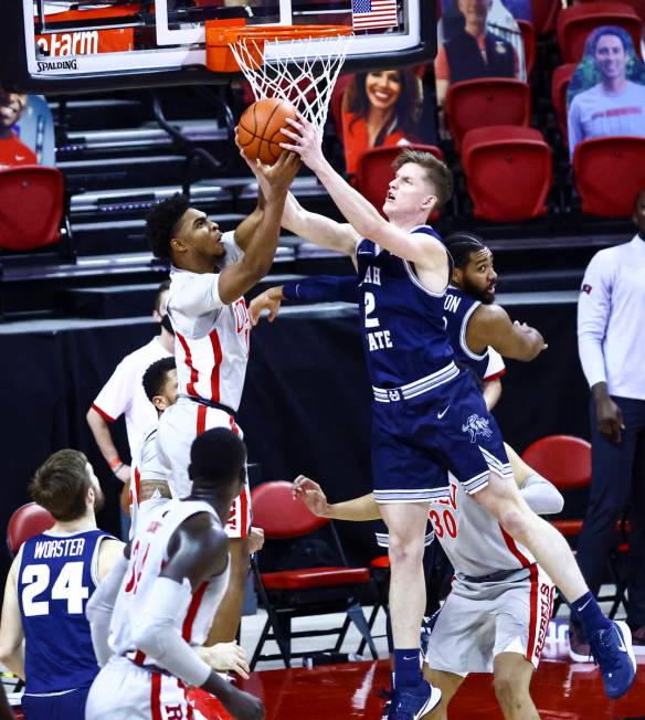 UNLV Rebels guard Bryce Hamilton (13) and Utah State Aggies guard Sean Bairstow (2) battle for ...