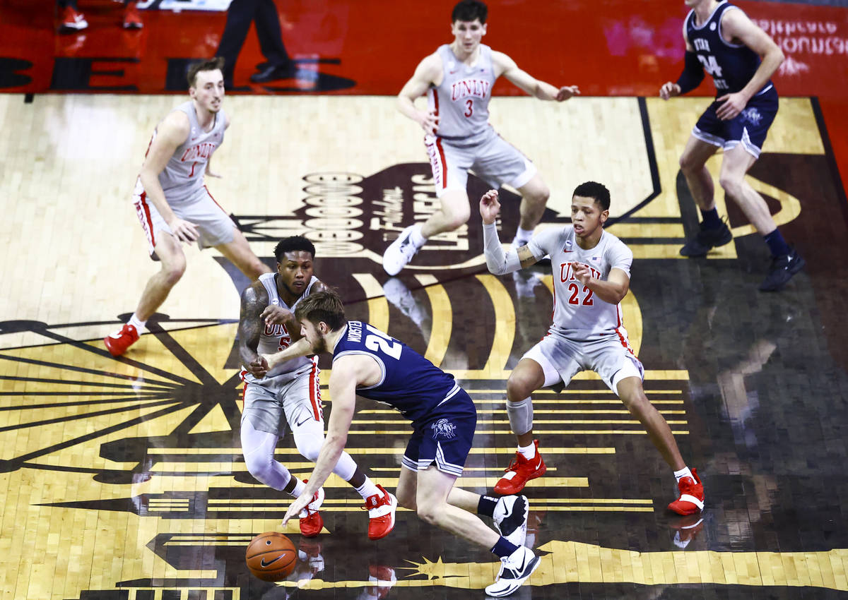 Utah State Aggies guard Rollie Worster (24) drives to the basket against UNLV Rebels guards Dav ...