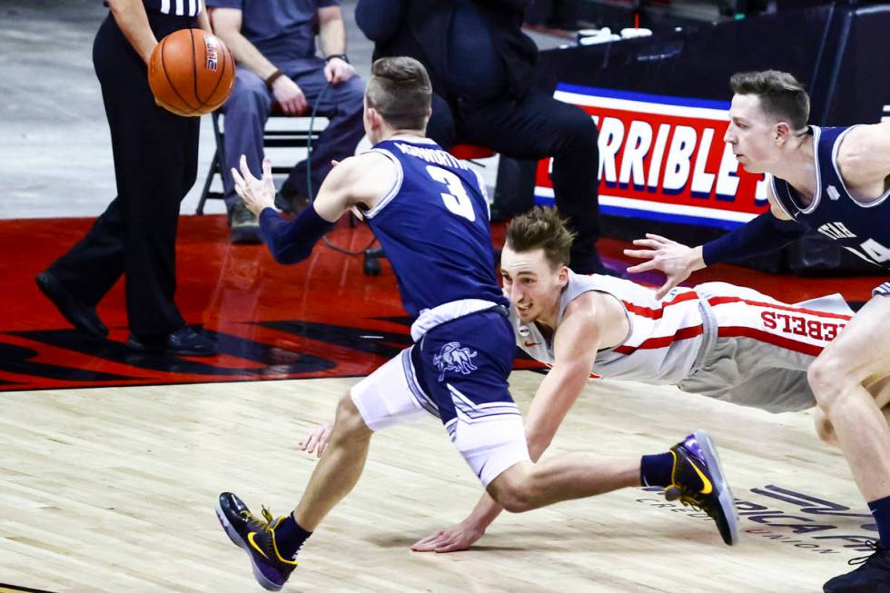 UNLV Rebels forward Moses Wood (1) dives for a rebound against Utah State Aggies guard Steven A ...