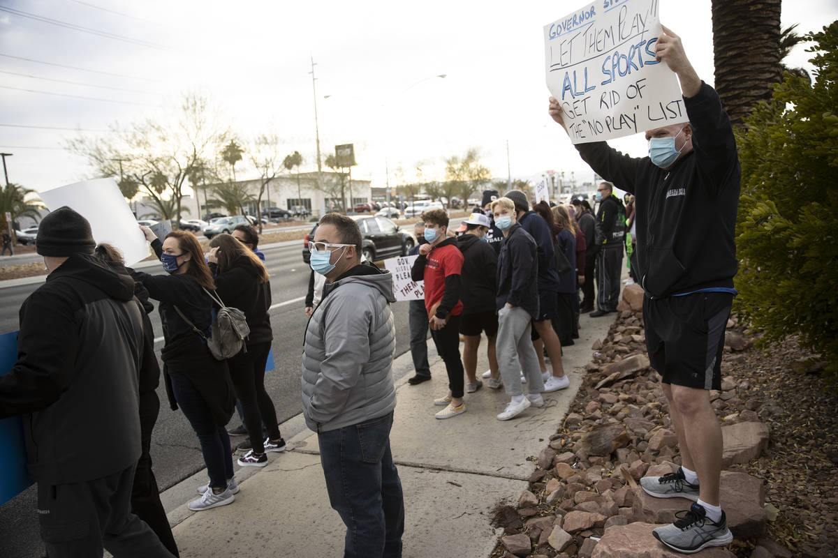 Bill Meyer, right, protests Clark County School District's decision to cancel winter and fall s ...