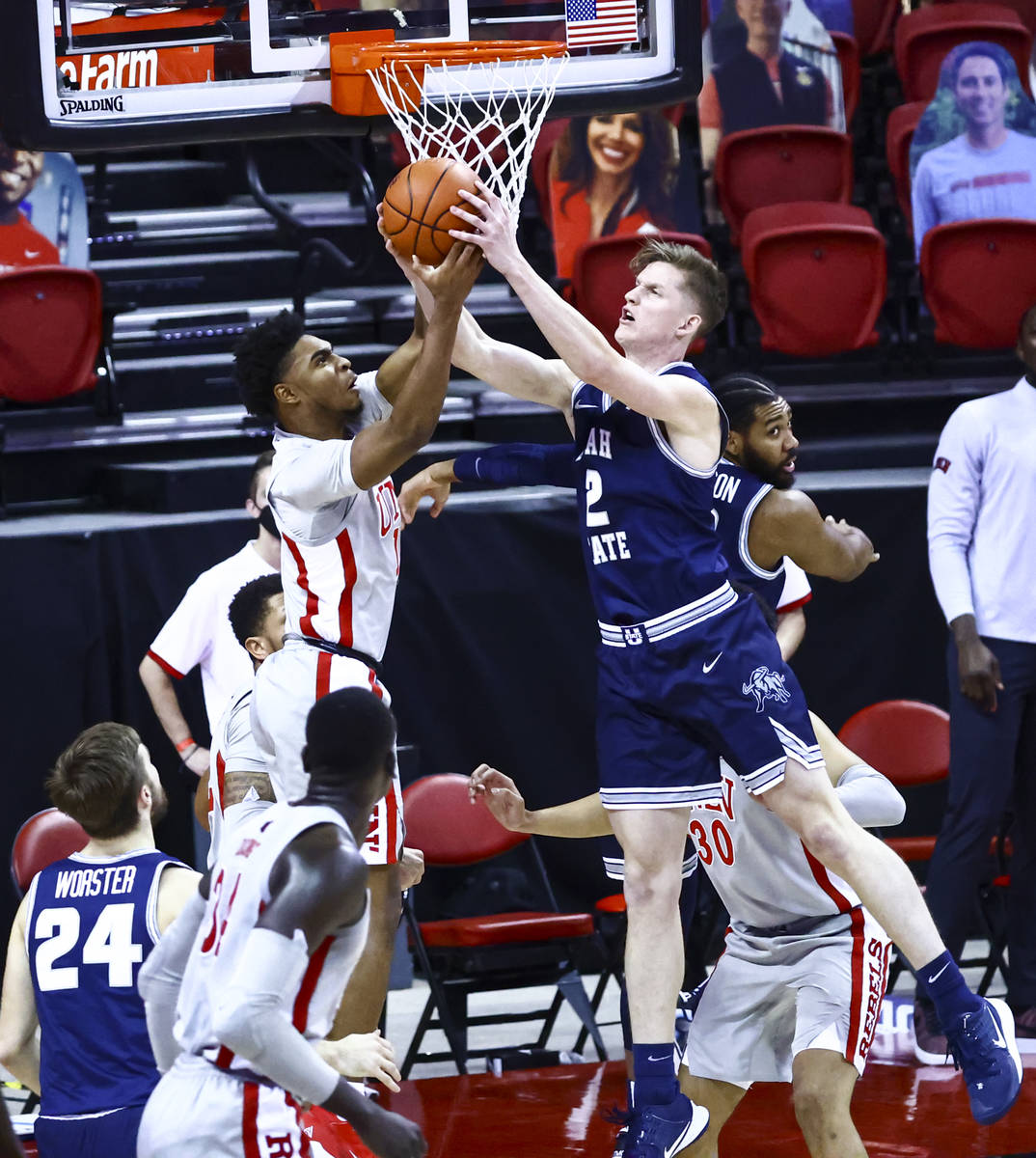 UNLV Rebels guard Bryce Hamilton (13) and Utah State Aggies guard Sean Bairstow (2) battle for ...