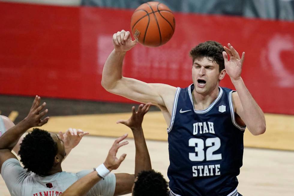 Utah State's Trevin Dorius (32) grabs a rebound over UNLV during the first half of an NCAA coll ...