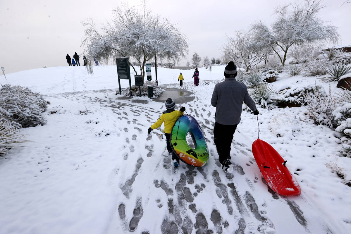 Colton Tarantino, 5, and his father Nick prepare to play in the snow at Fox Hill Park in Summer ...