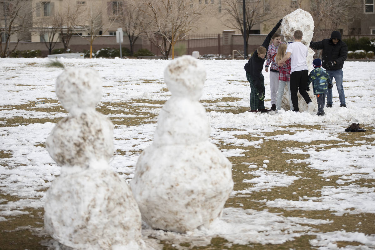 People play with the snow at Huckleberry Park in Las Vegas, on Tuesday, Jan. 26, 2021. (Erik Ve ...