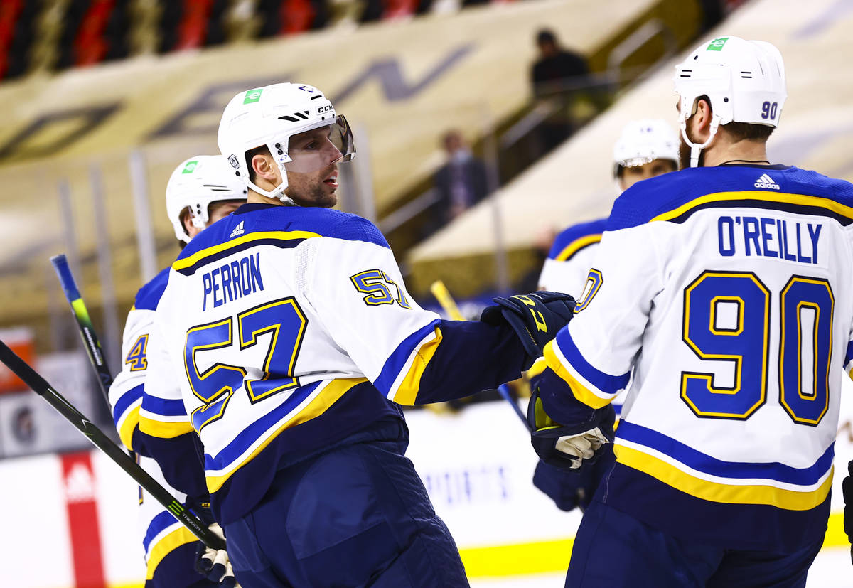 St. Louis Blues left wing David Perron (57) celebrates with his team after scoring against the ...