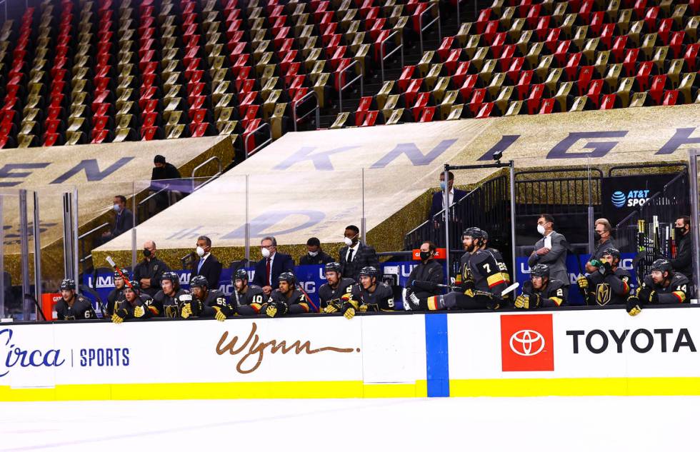 Empty seats are seen behind the Golden Knights bench during the first period of an NHL hockey g ...