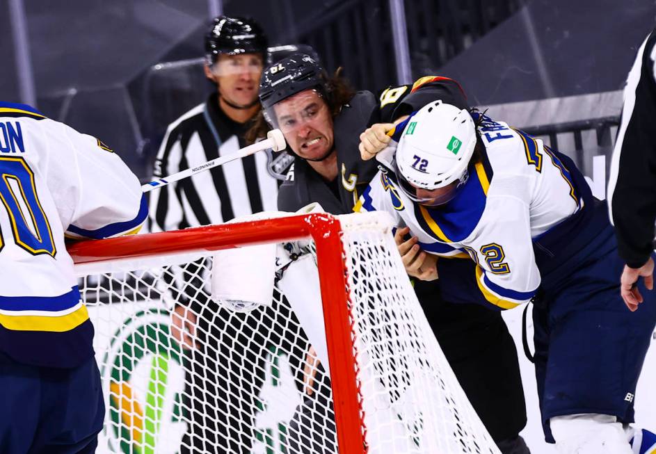 Golden Knights right wing Mark Stone (61) fights St. Louis Blues defenseman Justin Faulk (72) d ...