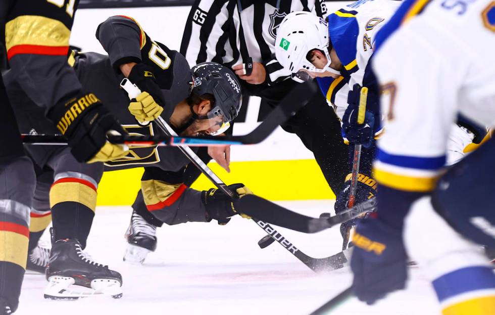 Golden Knights center Chandler Stephenson (20) and St. Louis Blues center Oskar Sundqvist (70) ...