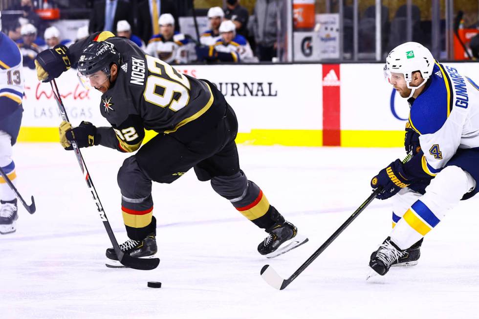 Golden Knights left wing Tomas Nosek (92) moves the puck around St. Louis Blues defenseman Carl ...