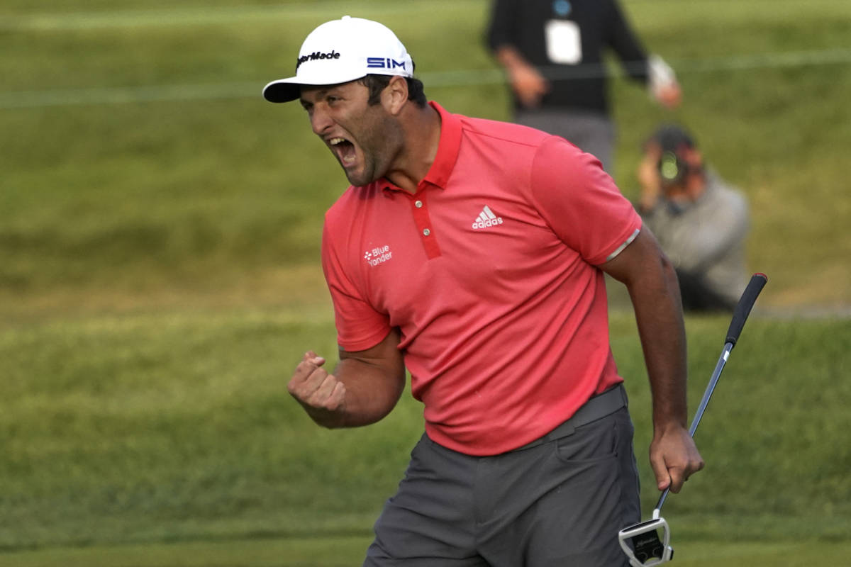 Jon Rahm reacts after making his putt on the first playoff hole during the final round of the B ...