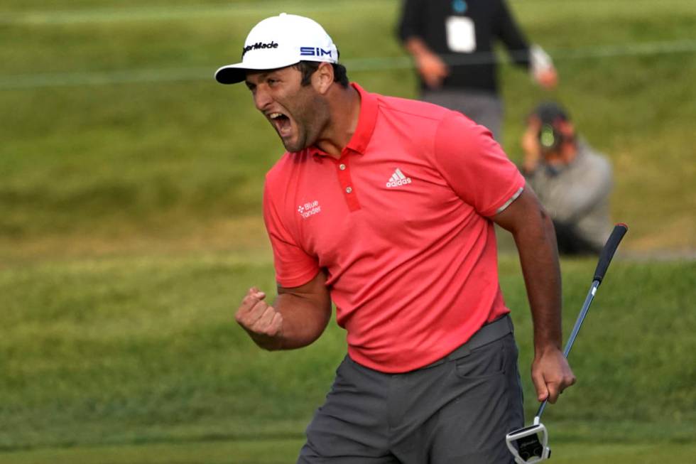 Jon Rahm reacts after making his putt on the first playoff hole during the final round of the B ...