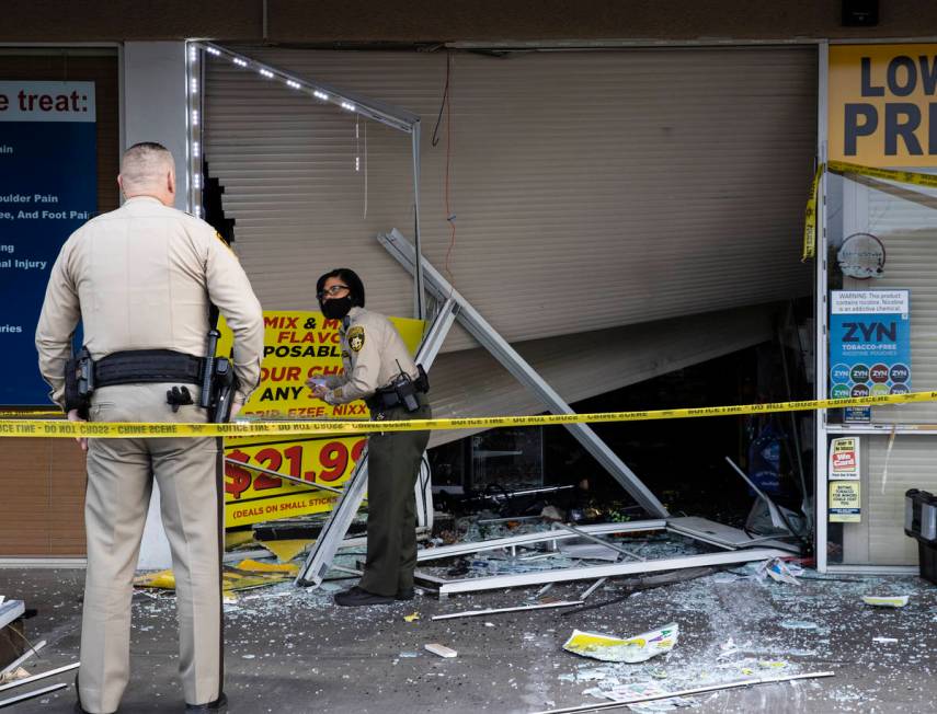 The Metropolitan Police Department investigates after a car crashed into a smoke shop as part o ...