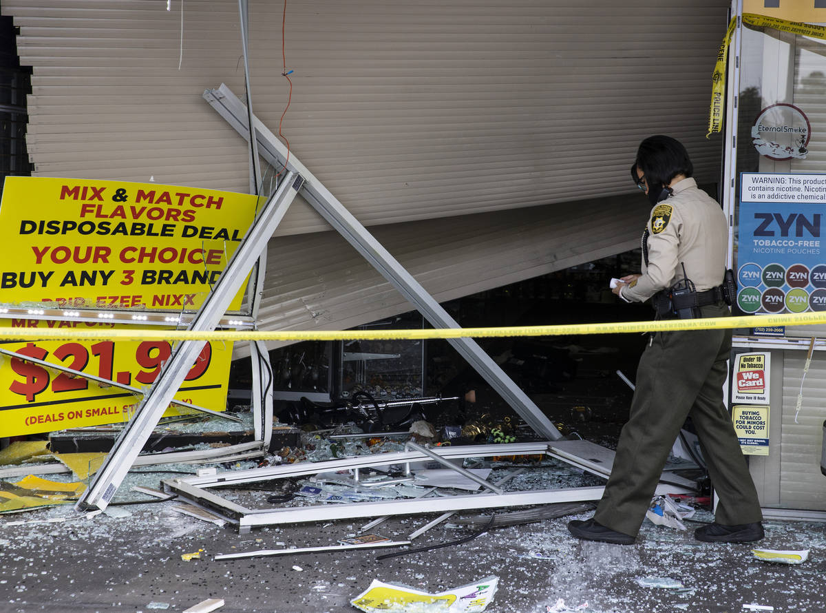 The Metropolitan Police Department investigates after a car crashed into a smoke shop as part o ...