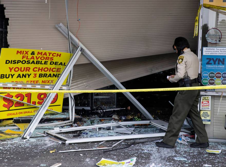 The Metropolitan Police Department investigates after a car crashed into a smoke shop as part o ...