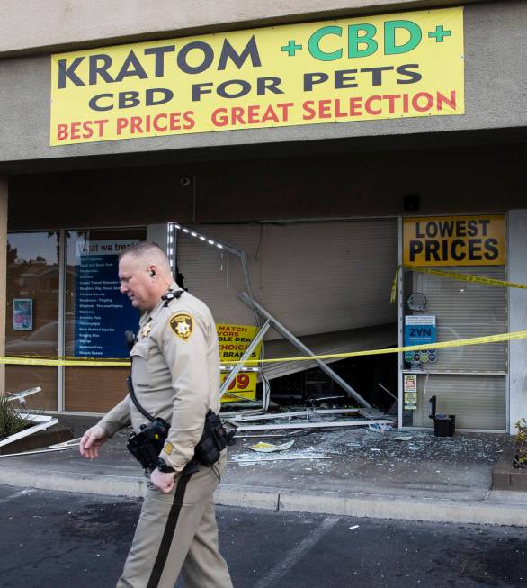 The Metropolitan Police Department investigates after a car crashed into a smoke shop as part o ...