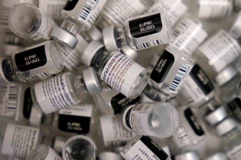 Empty vials of the Pfizer-BioNTech COVID-19 vaccine are seen at a vaccination center at UNLV in ...