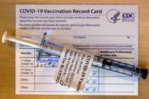 A pre-loaded shot and record card as some of the first veterans locally get their COVID-19 vacc ...