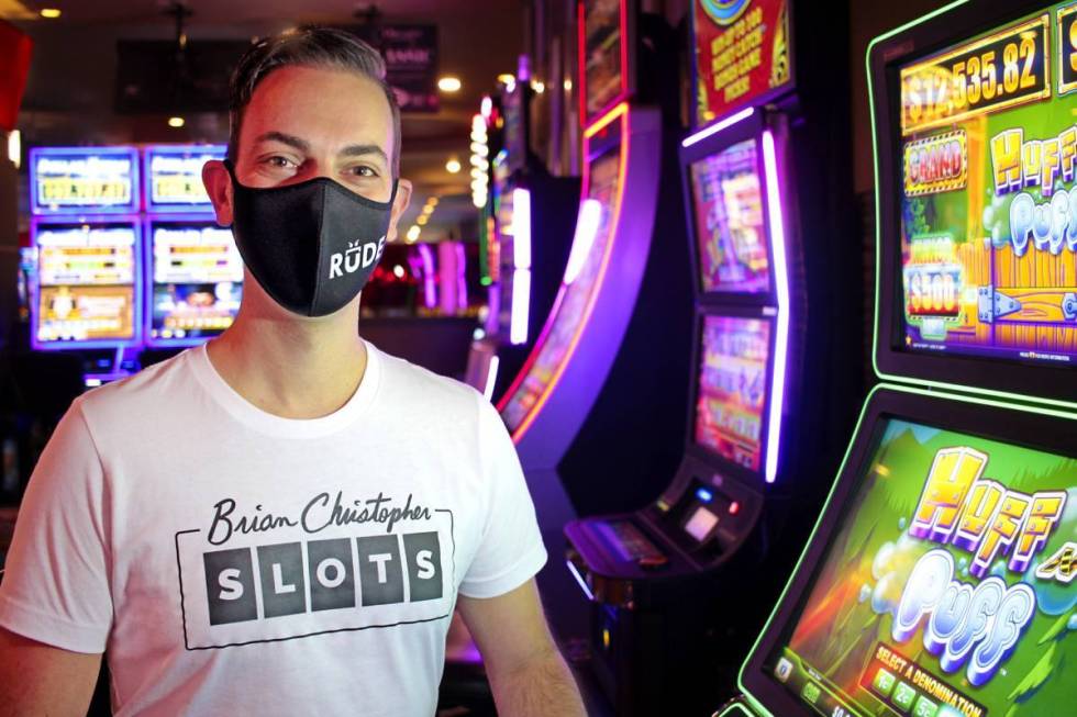 Brian Christopher poses next to a slot machine. (Courtesy, Brian Christopher Slots)