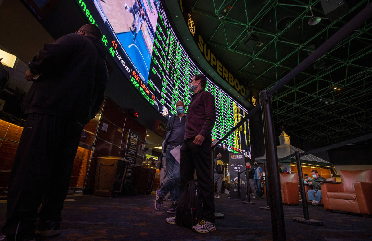Bettors wait in line to place their bets as the Westgate sportsbook posts hundreds of Super Bow ...