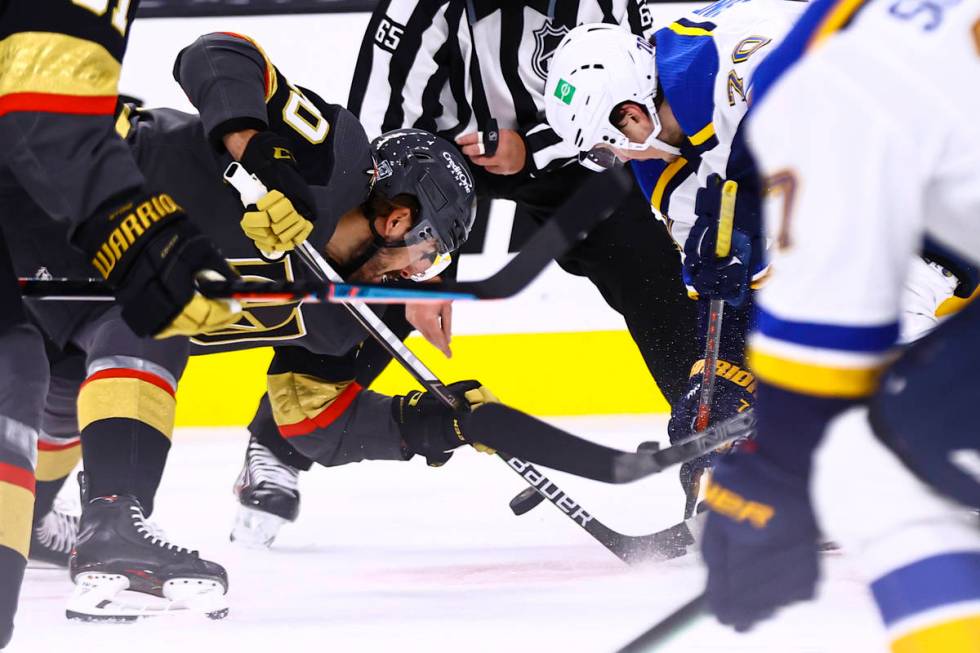 Golden Knights center Chandler Stephenson (20) and St. Louis Blues center Oskar Sundqvist (70) ...