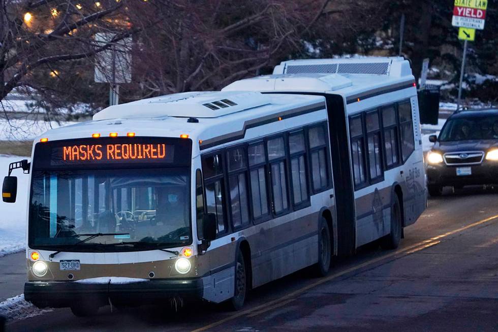 An electronic sign advises passengers that masks are required to ride a bus on the campus of th ...