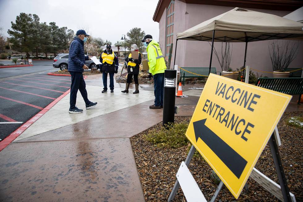 A person arrives to the vaccine entrance at the Sun City Anthem Community Center as volunteers ...