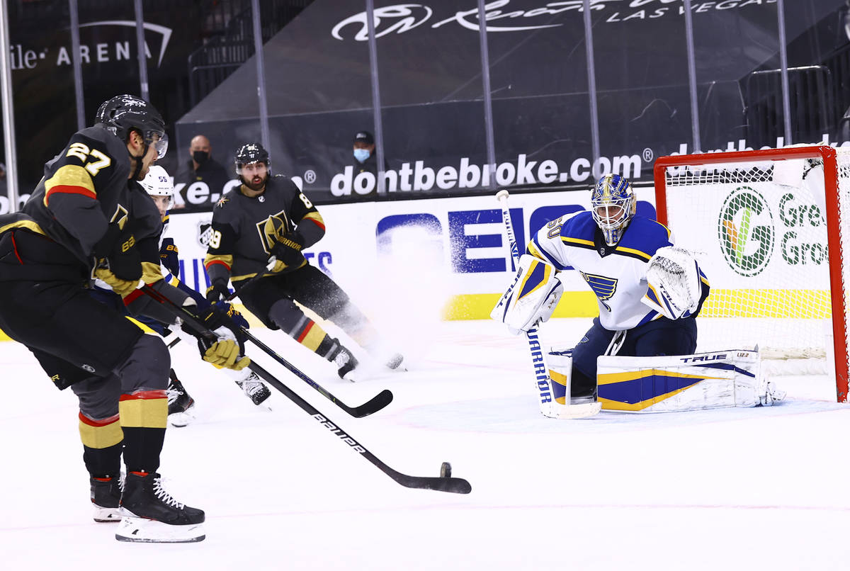 Golden Knights defenseman Shea Theodore (27) looks to shoot against St. Louis Blues goaltender ...