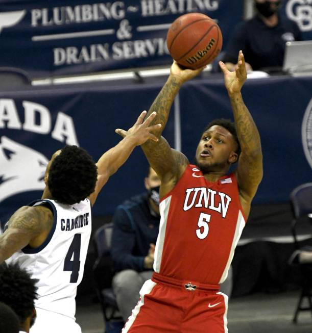 UNLV's David Jenkins shoots aganst UNR's Desmond Cambridge, Jr. in the first half of an NCAA co ...