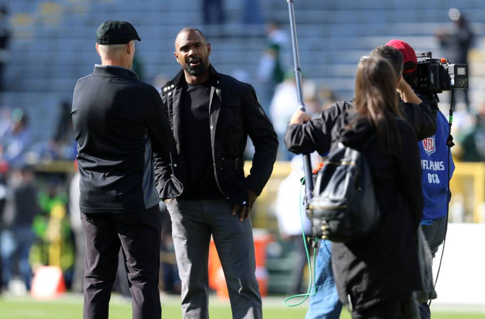 Oakland Raiders general manager Mike Mayock, left, speaks with former Raiders and Packers corne ...