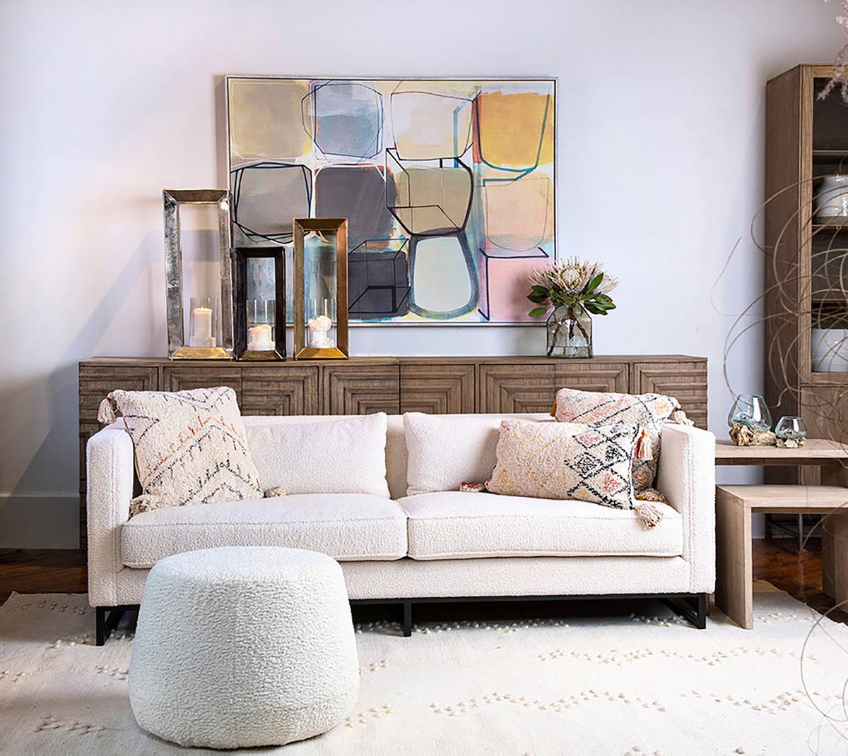Dovetail's Lynette sofa, made with a white poly blend fabric and metal base, is paired with its ...